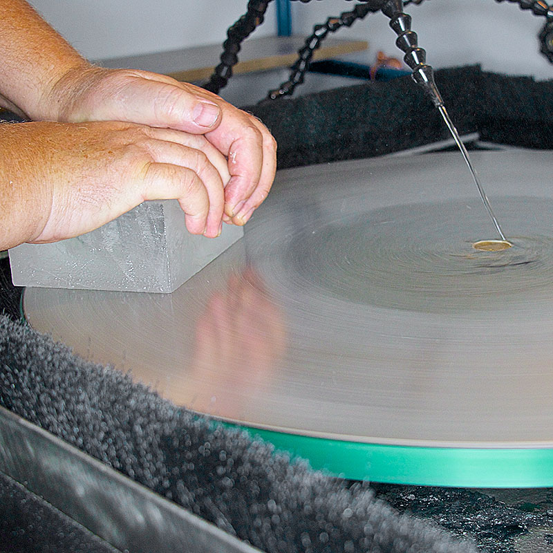 grinding a glass block on a flat lap grinder