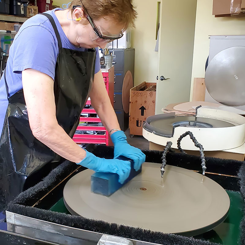 Ann Klem grinding glass on a diamond flat lap